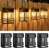 Set of four outdoor wall lights mounted on a wooden fence.